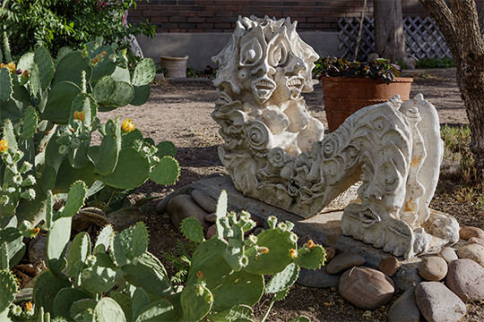 ho baron concrete sculpture of choc mol next to cacti