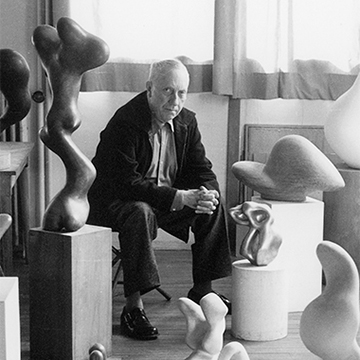 Black and white photo of artist Jean Arp in his studio