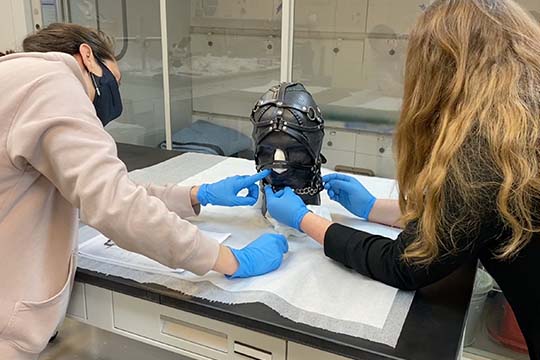 nasher conservation team adjusts the nancy grossman leather head sculpture